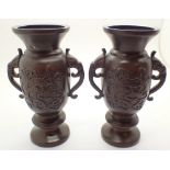 Pair of Oriental bronze dragon vases H: 15 cm