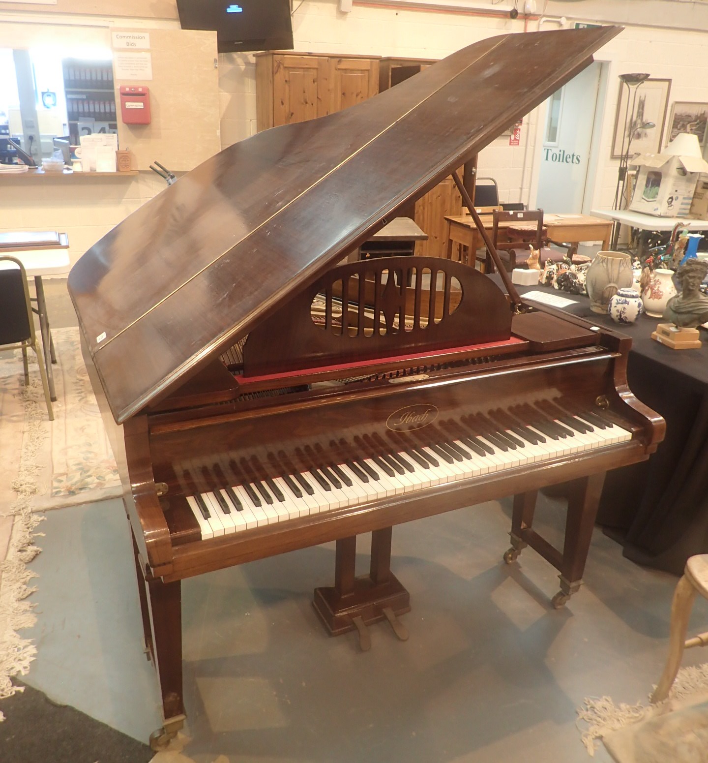 IBach baby grand piano in mahogany