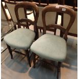 Two balloon back chairs and a modern glass and brass coffee table