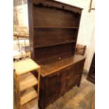 Large Arts and Crafts style dresser with three drawers and two cupboards in dark oak