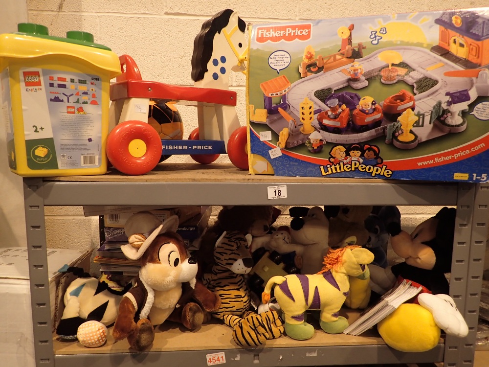 Shelf of Fisher Price toys games and soft toys