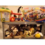 Shelf of Fisher Price toys games and soft toys