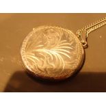 Circular silver locket on chain CONDITION REPORT: Diameter of locket = 3.