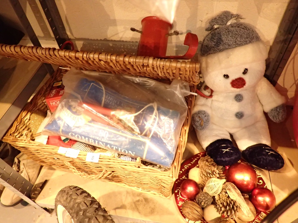 Wicker basket containing Christmas decorations and snowman teddy bear