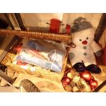 Wicker basket containing Christmas decorations and snowman teddy bear