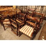 Six reproduction mahogany dining chairs including two carvers chairs upholstered in striped fabric