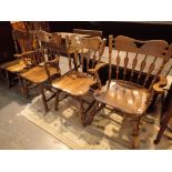 Four dark oak American dining chairs including two carvers