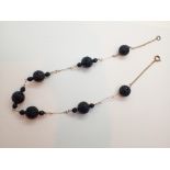 Yellow metal and black bead necklace