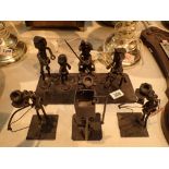 Four metal figurines including a group t