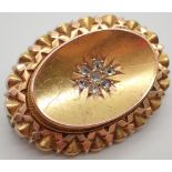 Victorian gold oval mourning brooch set with a cluster of seven old cut diamonds and having glazed