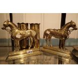 Matched pair of brass horse doorstops and a pair of trench art shell cases inscribed with fruit and