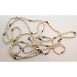 Vintage opera length natural pearl necklace having ( presumed and unmarked ) gold and haematite