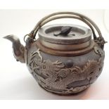Chinese metalware teapot with overlaid dragon and symbol decoration with seal mark to base
