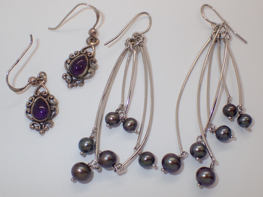 Two pairs of silver drop earrings one genuine pearl and one amethyst