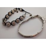 Two bracelets one shamballa one stainless steel