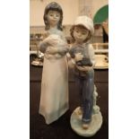 Pair of Lladro and Nao boy / girl and puppy figurines