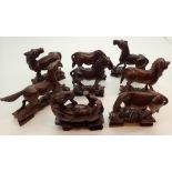 Set of eight Chinese carved hardwood horses of Mu Wang with inset eyes H: 8 cm