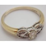 18ct gold and diamond ring the large central diamond flanked by ten smaller diamonds size O / P 3.