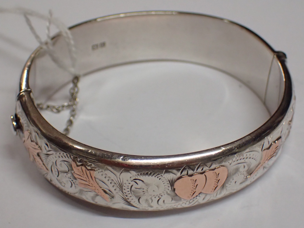 Silver bangle with rose gold highlights