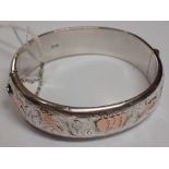 Silver bangle with rose gold highlights