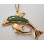 New Zealand made nephrite jade and yellow metal dolphin on a plated chain