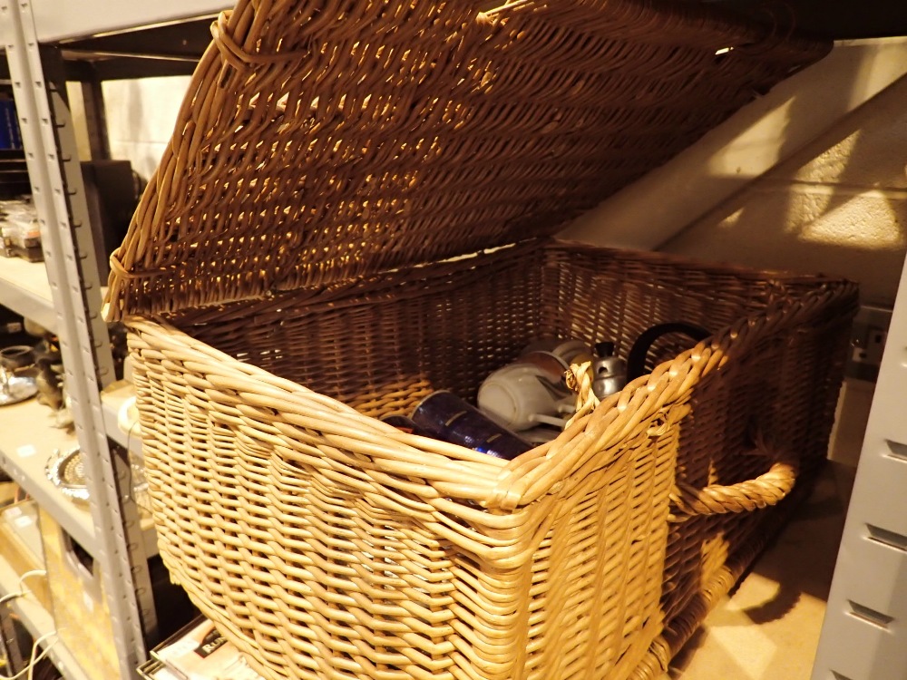 Wicker picnic basket containing gas cylinders