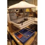 Two bird cages with internal fittings