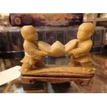 Oriental carved soapstone of two children carving a lotus flower A/F CONDITION REPORT: