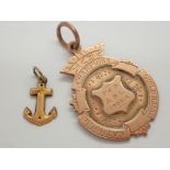 9ct gold fob and a 9ct gold small anchor charm 5.