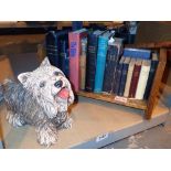 Dog door stop with an oak bookshelf containing bibles