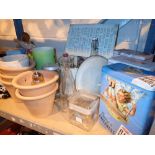 Shelf of mixed items advertising tins terracotta planters etc