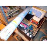 Box of mixed stationary items including pens etc with a world map