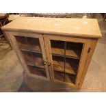 Small pine cupboard with glazed and lead doors and three shelves 74 x 27 x 74 cm