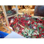 Two shelves of Christmas decorations including wreaths