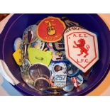 Tub of cloth badges and pin badges with various designs