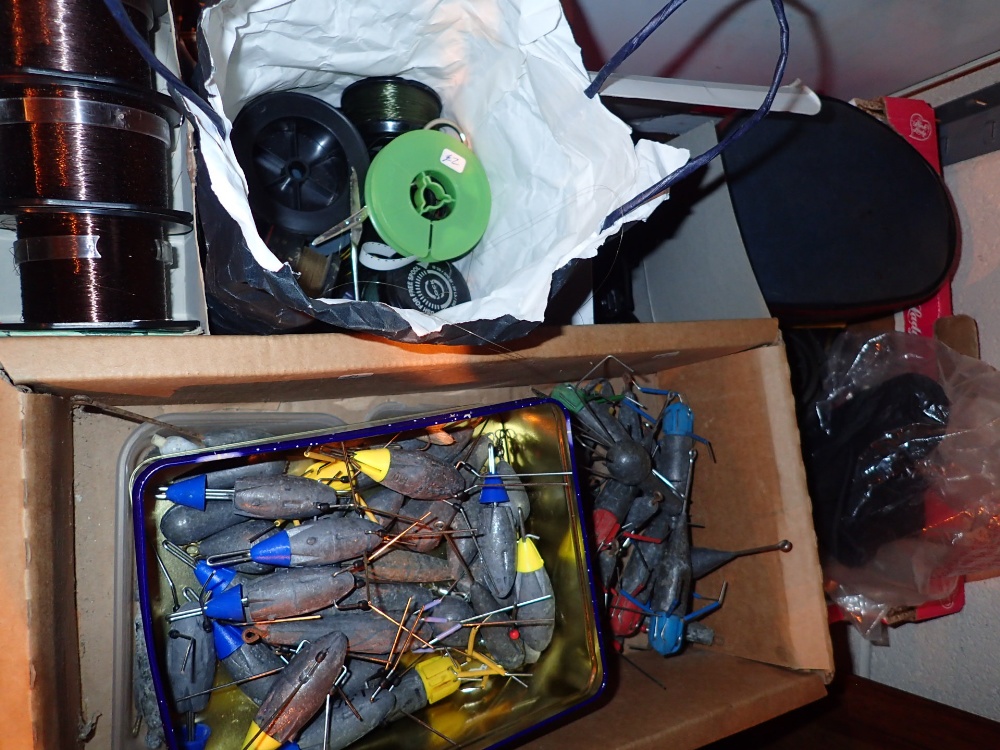 Box of mixed fishing items to include fishing weights lines and reels