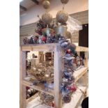 Three shelves of Christmas decorations to include a village diorama