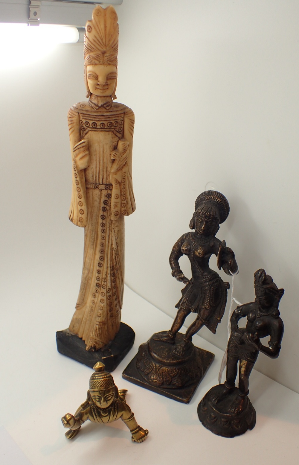 Four Eastern God figurines including bon