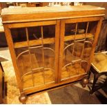 Glazed oak bookcase with ball supports 9