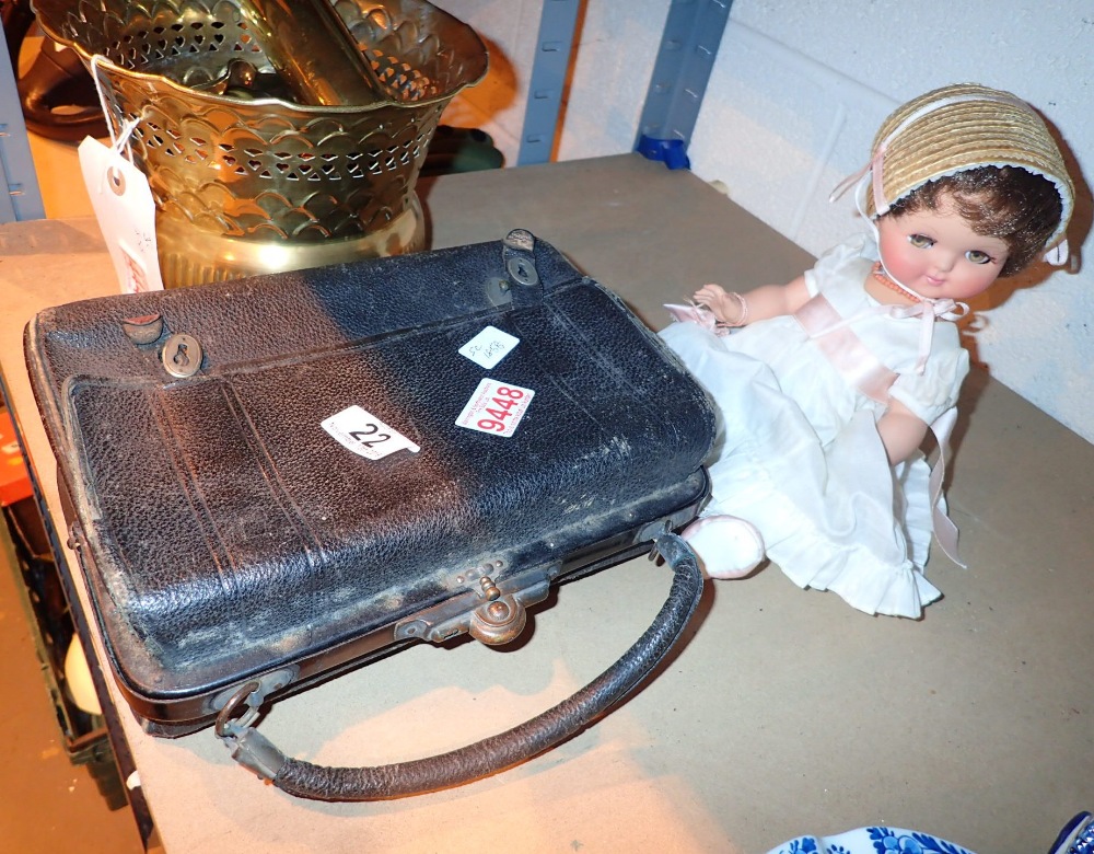 Antique leather bag and doll with hand e