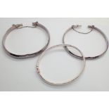 Three vintage silver hinged bangles