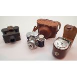 Two vintage miniature cameras and a ligh