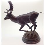 Bronze model of running stag on circular