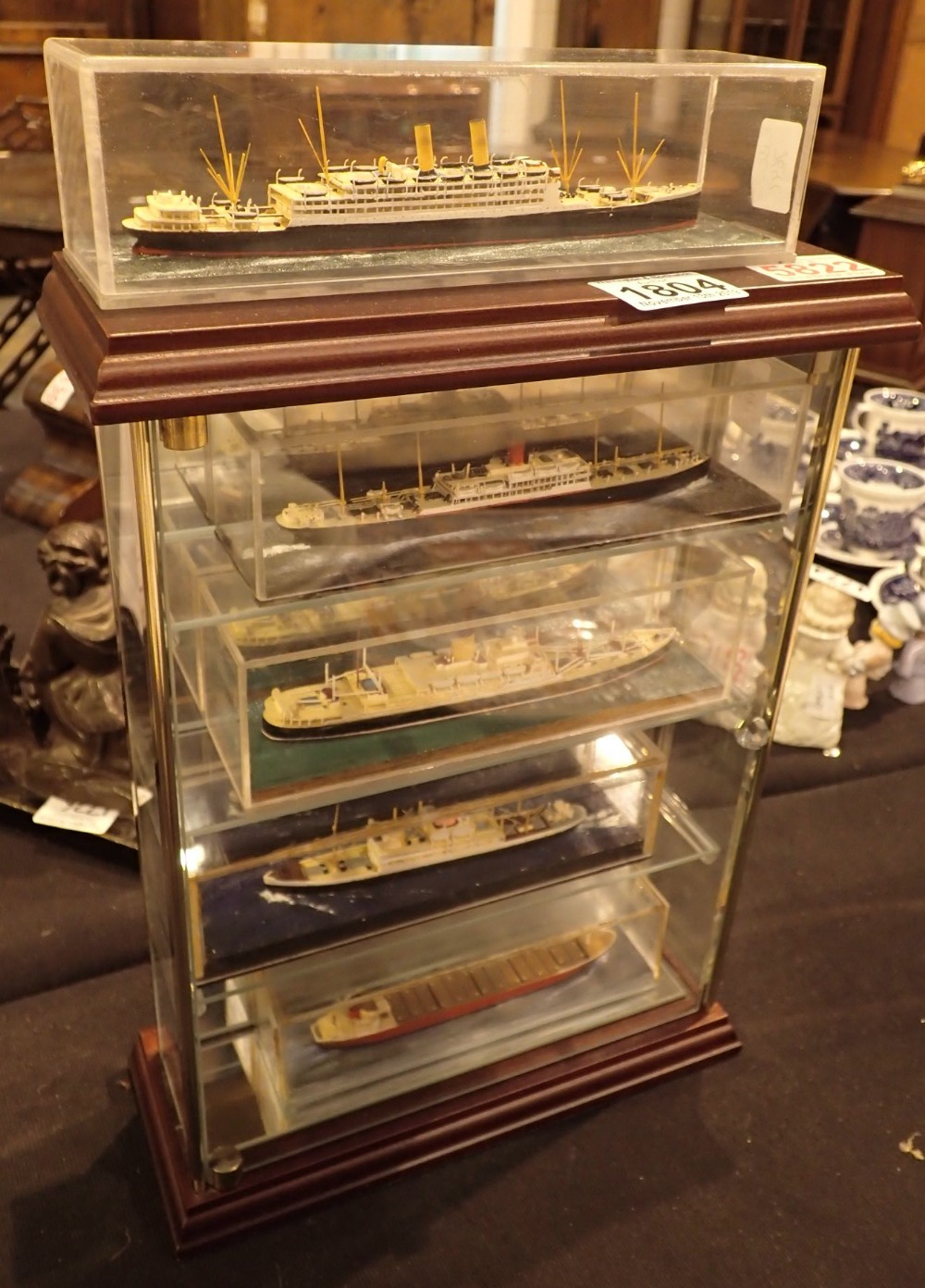 Five handmade miniature ships in cases