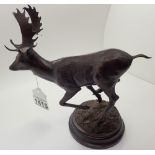 Bronze model of running stag on circular domed naturalistic base signed Dashwood 5/9 brown
