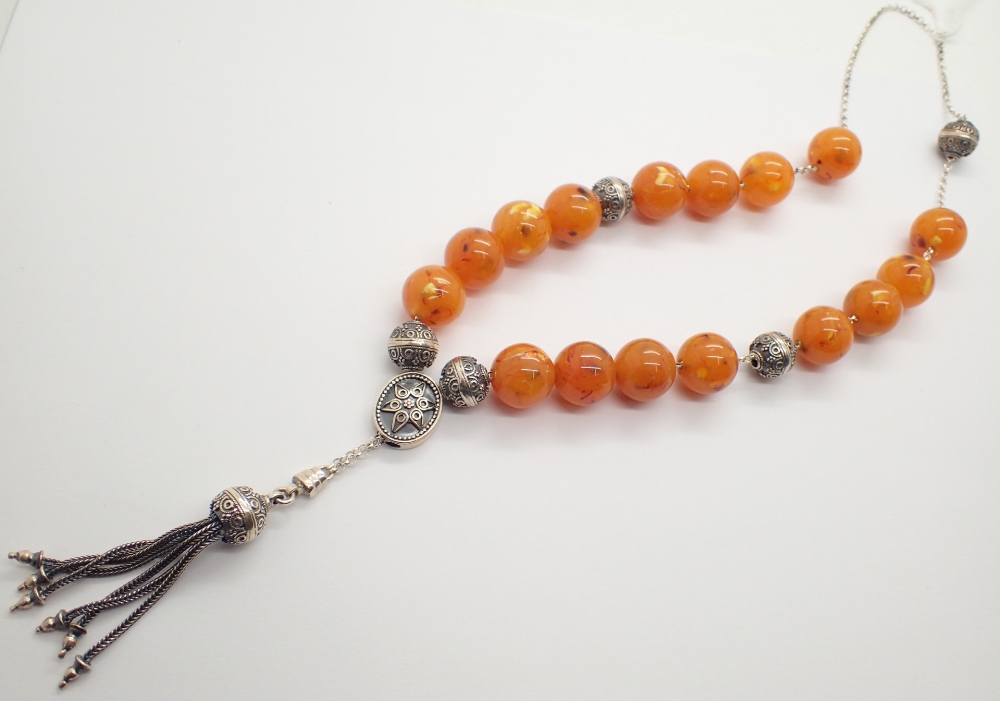 Egg yolk amber style and white metal prayer beads stamped Anagnostou?