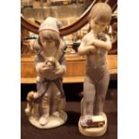 Two Lladro children figurines girl with puppies and boy with truck