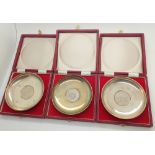 Three hallmarked silver dishes / ashtrays in boxes assay London 1972 all with inset coins total