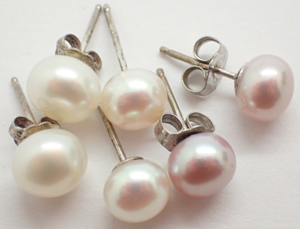 Three pairs of new old stock genuine pearl and silver stud earrings