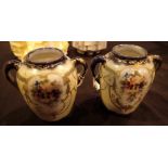 Pair of small twin handled vases decorated with hand painted flowers and gilding H: 9 cm